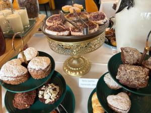 a display of different types of donuts and pastries at Hotel República Boutique Hotel in Tomar