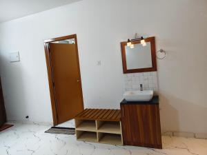 a bathroom with a sink and a mirror at krishna madhavam in Guruvāyūr +9 photos