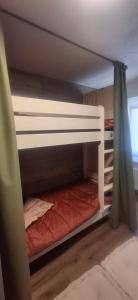 two bunk beds in a room with a bed at Inner Holiday Dolomites in Dimaro