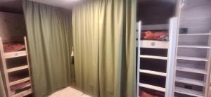 a bedroom with green curtains and a closet at Inner Holiday Dolomites in Dimaro +81 photos