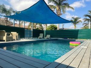 a swimming pool with a blue tarp over it at סוויטות חלב ודבש in Kefar Zetim