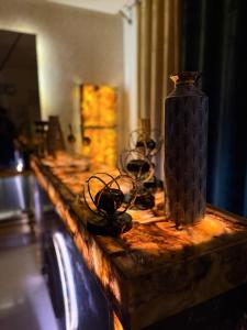 a table with glasses and a vase on it at Prestige Home in Lahore