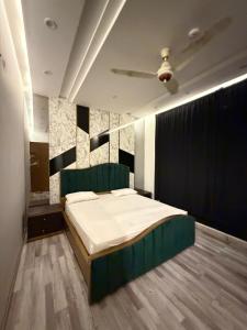 a bedroom with a bed and a ceiling at Prestige Home in Lahore