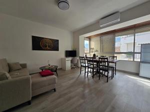 a living room with a couch and a table and chairs at Simat Malina 2 in Simat de Valldigna