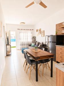 a kitchen and living room with a wooden table and chairs at Andromeda Apartment in Polis Chrysochous