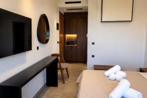 a hotel room with two beds and a television at Stella View in Pefki