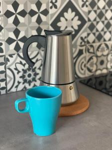 a tea kettle and a blue cup on a counter at Simat Malina 2 in Simat de Valldigna +3 photos