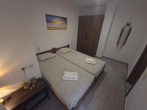 a bedroom with a bed with two towels on it at Simat Malina 2 in Simat de Valldigna