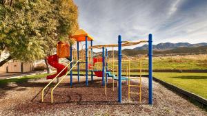 a playground with a slide in a park at Best Western Paradise Inn in Nephi