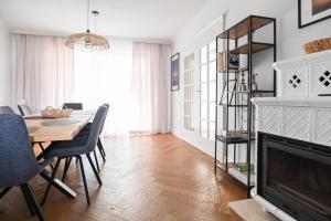 a living room with a dining room table and a television at Villa Laurent in Charzykowy