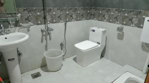a bathroom with a toilet and a sink at Royal Palace in Naran