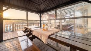 a room with benches and tables on a deck at Daebudo Sketch Pension in Ansan