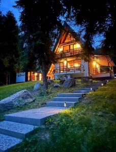 a house with stairs leading up to it at night at Green-in in Jaklovce