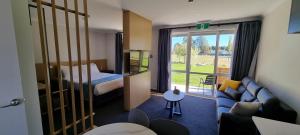 a hotel room with a bed and a couch at Hideaway of Rotorua in Rotorua