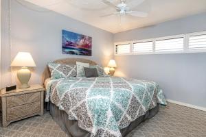 a bedroom with a bed and a ceiling fan at SUGAR BEACH RESORT, #319 in Kihei