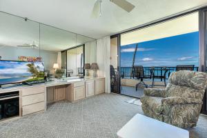 a living room with a television and a couch and a chair at SUGAR BEACH RESORT, #319 in Kihei +27 photos