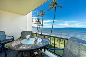 a table on a balcony with a view of the ocean at SUGAR BEACH RESORT, #319 in Kihei
