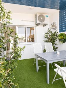 a patio with a table and chairs on grass at Andromeda Apartment in Polis Chrysochous +9 photos