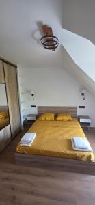 a bedroom with a large bed with yellow sheets at Ker Giz 14 in Arzon +6 photos