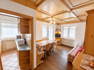 a kitchen and dining room with a table and chairs at Appartamento Cuore by AMA Val di Fassa in Campitello di Fassa
