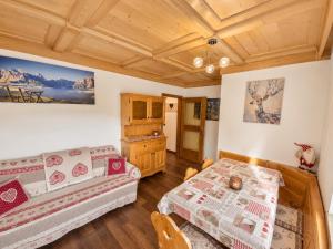 a living room with two beds and a couch at Appartamento Cuore by AMA Val di Fassa in Campitello di Fassa