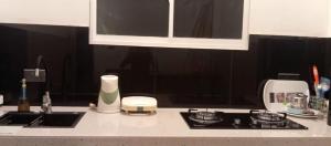 a kitchen counter with a stove and a sink at Holiday Apartment Ragama in Kurukulawa +2 photos