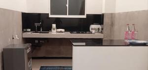 a kitchen with a stove and a counter top at Holiday Apartment Ragama in Kurukulawa