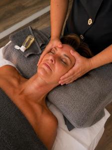 a woman laying on a towel with her hands on her head at "L Eden enchanté" Chambres d'hôtes et Bulle d'Eden Spa Massages Boucau Côte Basque in Boucau