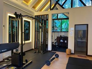 a room with a gym with treadmills and weights at Sada Hotel in Luang Prabang