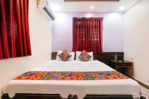 a bedroom with a large bed with red curtains at Via Sagar Darshan in Panaji +26 photos