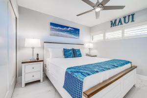 a white bedroom with a bed and a ceiling fan at SUGAR BEACH RESORT, #PH27 in Kihei
