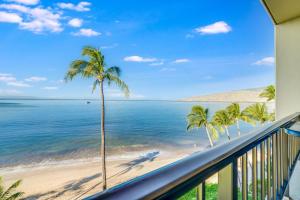 a balcony with a view of the beach and palm trees at SUGAR BEACH RESORT, #PH27 in Kihei +33 photos