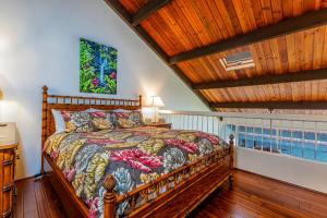 a bedroom with a bed and a wooden ceiling at Hale Mahina #B-405 in Honokowai
