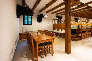 a dining room with a wooden table and chairs at Hotel Selsky Dvur in Vyškov