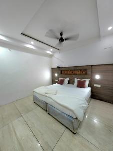 a bedroom with a large bed with a ceiling at Classic Hotel in Pānīpat +9 photos