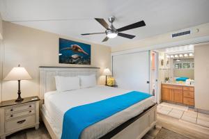 a bedroom with a bed and a bathroom at SUGAR BEACH RESORT, #409 in Kihei