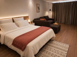a hotel room with a large bed and a couch at Suider Ozias Self Catering in Windhoek