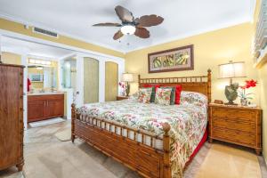 a bedroom with a bed and a ceiling fan at SUGAR BEACH RESORT, #131 in Kihei
