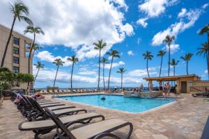 a pool at the beach resort with palm trees at SUGAR BEACH RESORT, #131 in Kihei