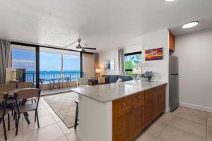 a kitchen and living room with a view of the ocean at SUGAR BEACH RESORT, #235 in Kihei
