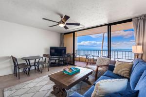 a living room with a blue couch and a table at SUGAR BEACH RESORT, #235 in Kihei