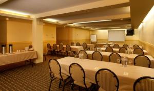 a conference room with tables and chairs and a podium at Best Western Plus Mont-Laurier in Mont-Laurier