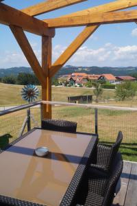 a patio with a table and chairs on a deck at Tiny House Auszeit in Nabegg