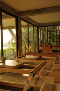a room with a bunch of tables and windows at Kurulu Bay in Ahangama