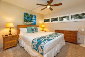 a bedroom with a bed and a ceiling fan at SUGAR BEACH RESORT #227 in Kihei