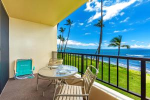 a balcony with a table and chairs and the ocean at SUGAR BEACH RESORT #227 in Kihei