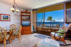 a living room with a view of the ocean at SUGAR BEACH RESORT #227 in Kihei +32 photos
