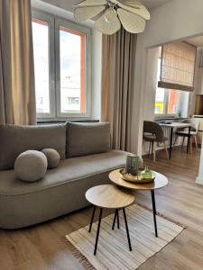 a living room with a couch and a table at Kaszmir Studio in Tarnowskie Góry