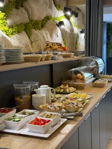 a buffet with many different food items on a table at Hotel Krystyna in Szczytno +30 photos
