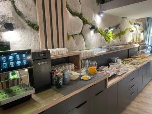 a kitchen with a counter with food on it at Hotel Krystyna in Szczytno